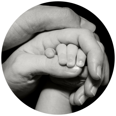 Emotional support for families. Father, mother and baby holding hands.